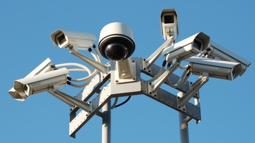 Why are infrared lenses widely used in security monitoring?